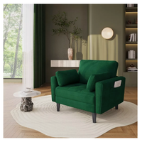 Fotel welurowy zielony do salonu z poduszkami