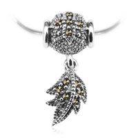 srebrny wisiorek przekładany z piórkiem i markazytami