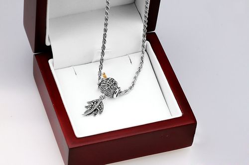 srebrny wisiorek przekładany z piórkiem i markazytami na Arena.pl