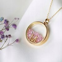 Naszyjnik złoty sekretnik z różową cyrkonią z literką