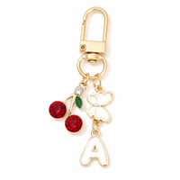 Brelok literka "a" złoty z wisienkami i motylkiem